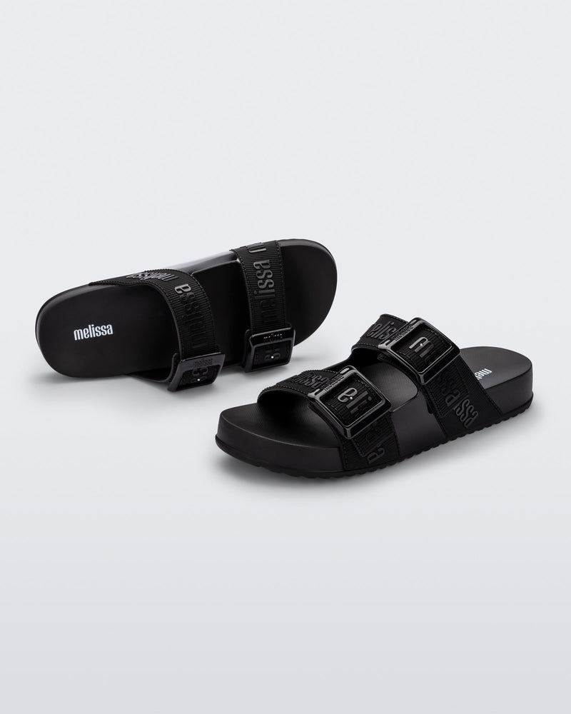Top and angled view of a pair of black Cozy M Love adult slides