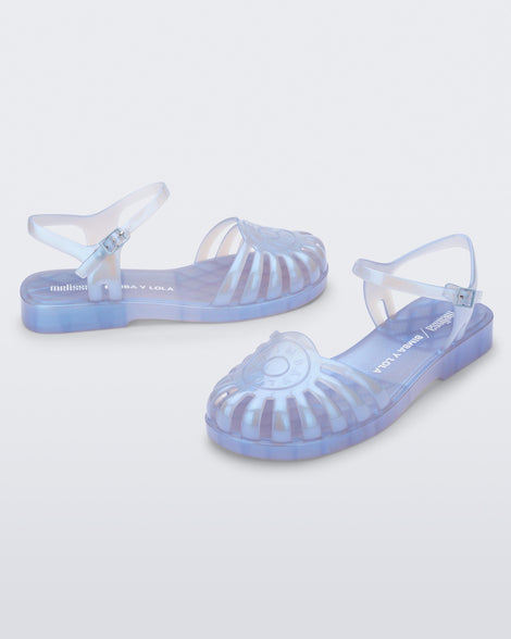 Angled view of a pair of the pearly blue Sandal + Bimba y Lola with ankle strap