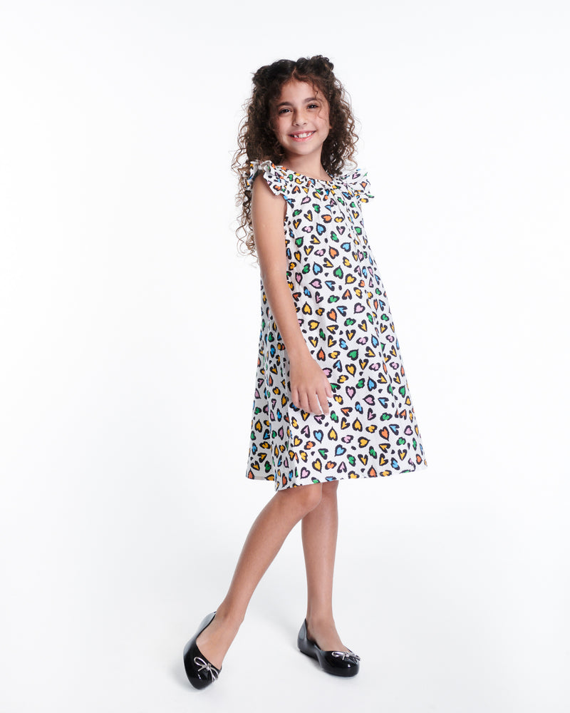 Child model in a dress wearing a pair of black Sweet Love Chrome kids flats with metallic silver bow