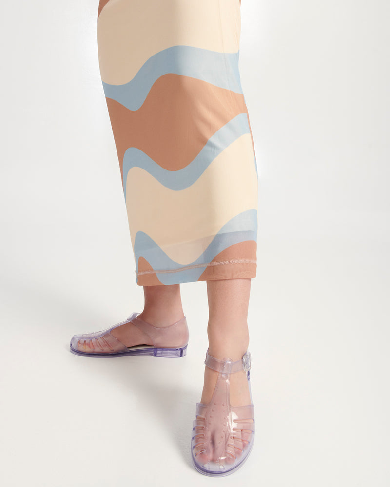Model's legs wearing a pair of clear Aranha 79 flats with buckle
