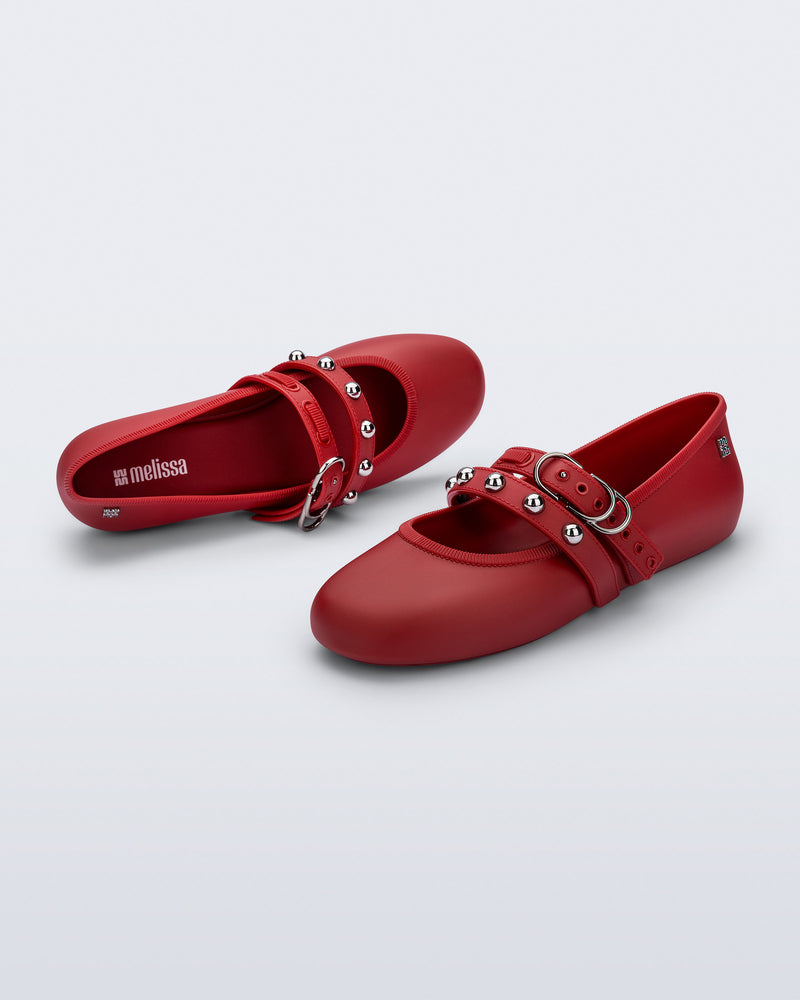 Top and angled view of a pair of red Soft Ballerina Studs flats with silver embellishments