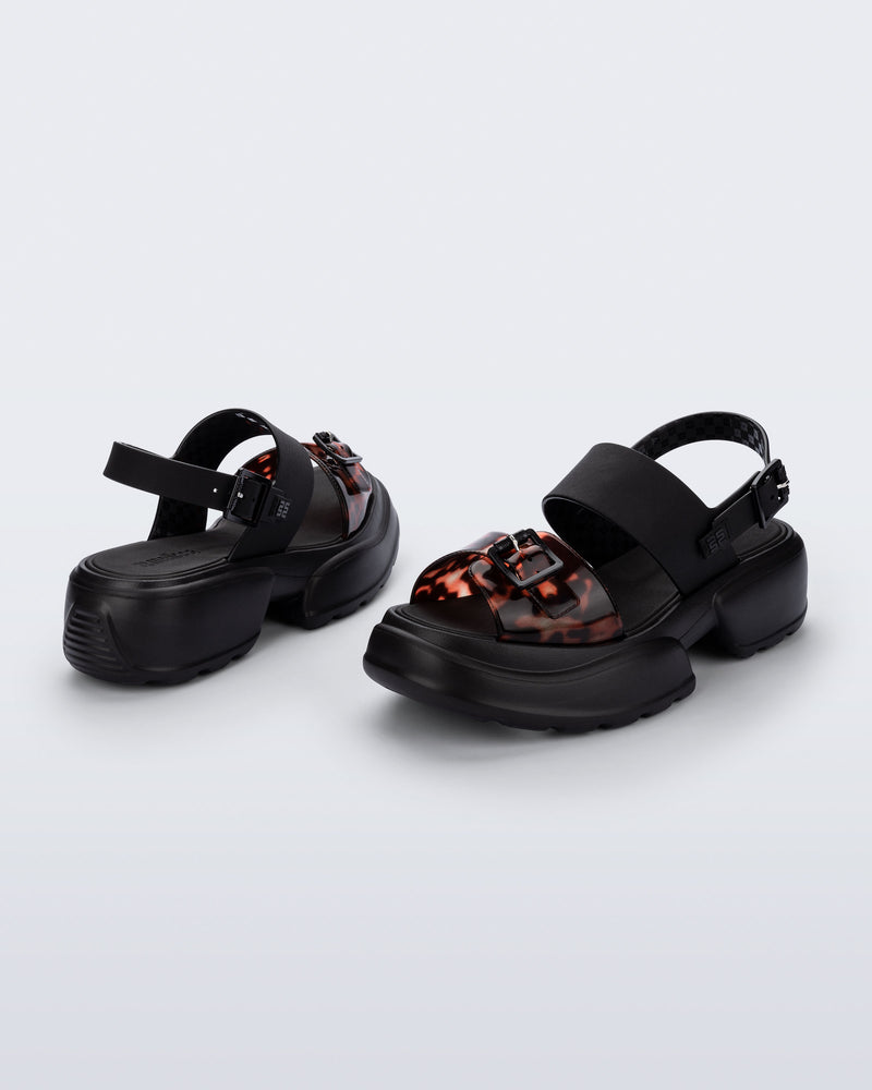Back and angled view of a pair of black Push platform Sandals with tortoise colored strap