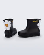 Side and back view of a pair of black Welly Bloomy boots with white daisy on back