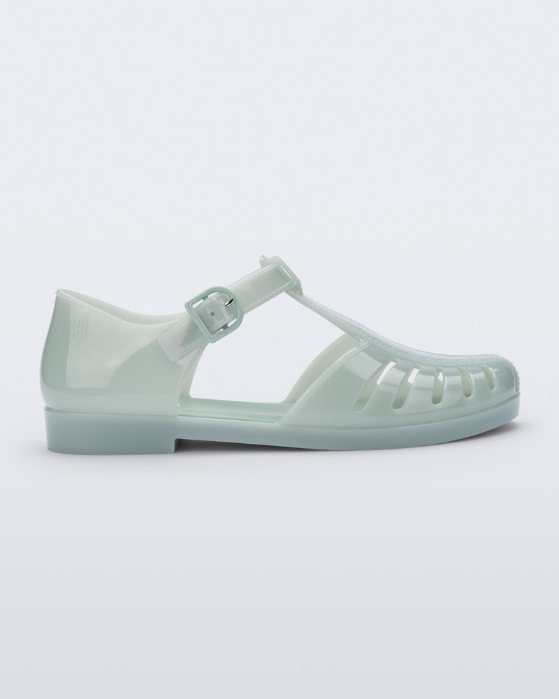 Side view of a milky green Aranha 79 flat with buckle