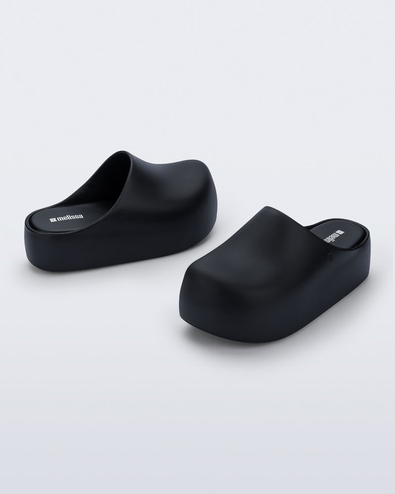 Side and angled view of a pair of black Free Clog Up Platforms