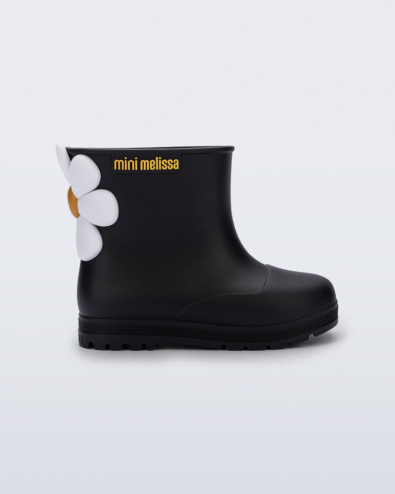Side view of a black Welly Bloomy boot with white daisy on back