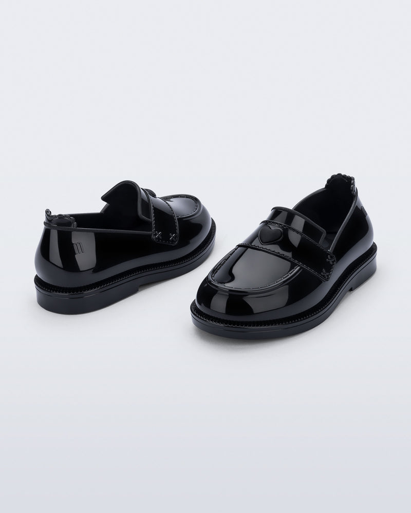 Back and angled view of a pair of black Royal Love baby loafers