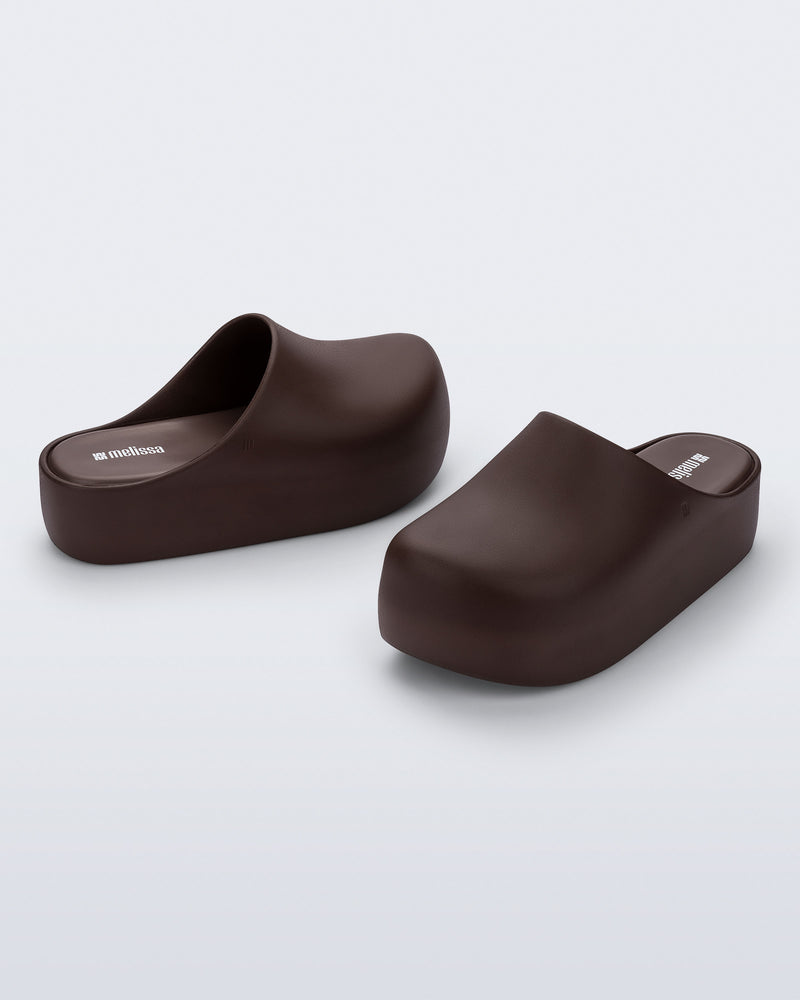 Side and angled view of a pair of brown Free Clog Up Platforms