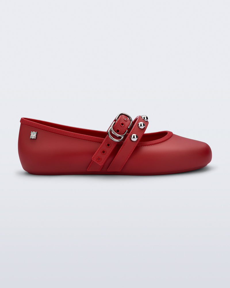 Side view of a red Soft Ballerina Studs flat with silver embellishments