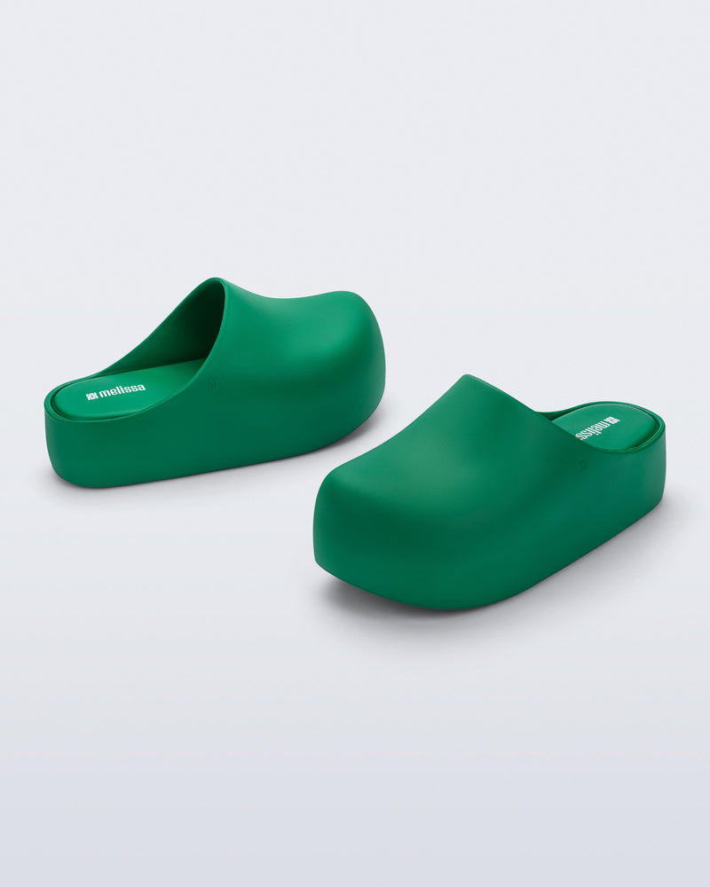 Side and angled view of a pair of green Free Clog Up Platforms