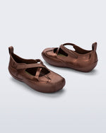 Back and angled view of a pair of bronze Aira flats with top straps