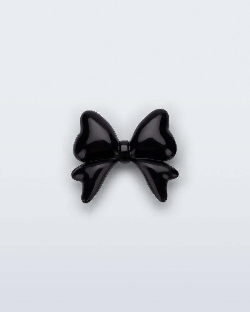 Front view of a black bow shoe charm