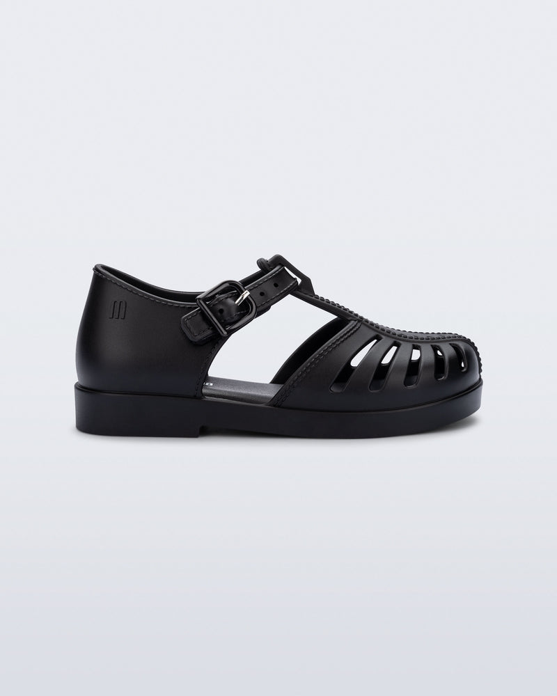 Side view of a black Aranha 79 baby flat with buckle