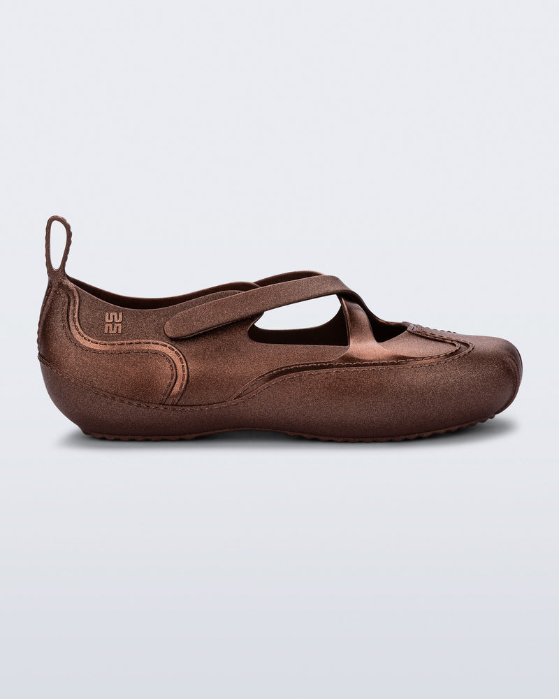 Side view of a bronze Aira flat with top straps