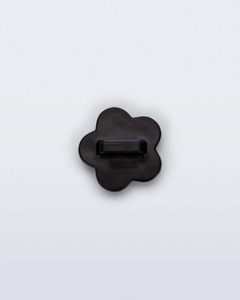 Back view of a black flower shoe charm