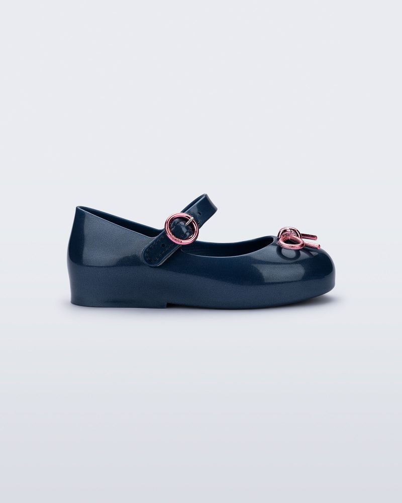 Side view of a blue Sweet Love Chrome baby flat with metallic pink bow and buckle