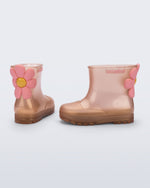 Side and back view of a pair of pearly pink Welly Bloomy boots with pink daisy on back