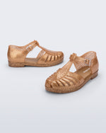 Side and angled view of a pair of glitter gold Aranha 79 kids flats with buckle