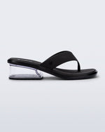 Side view of a black Margot flip flop with clear low heel
