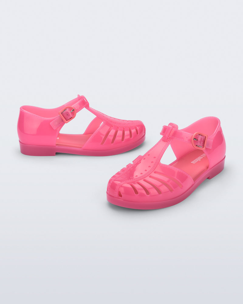 Side and angled view of a pair of pink Aranha 79 kids flats with buckle