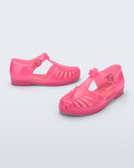 Side and angled view of a pair of pink Aranha 79 kids flats with buckle