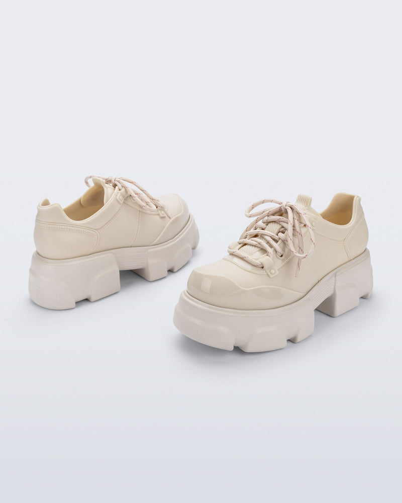 Back and angled view of a pair of beige Camp platform Sneakers with beige laces