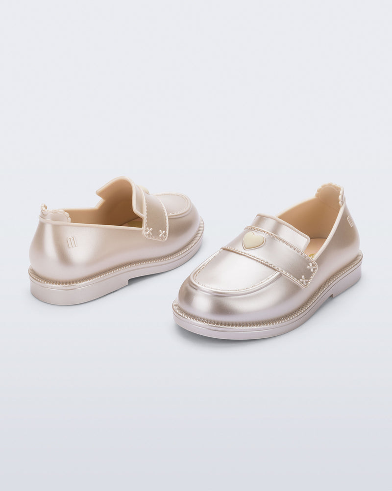 Back and angled view of a pair of metallic beige Royal Love baby loafers