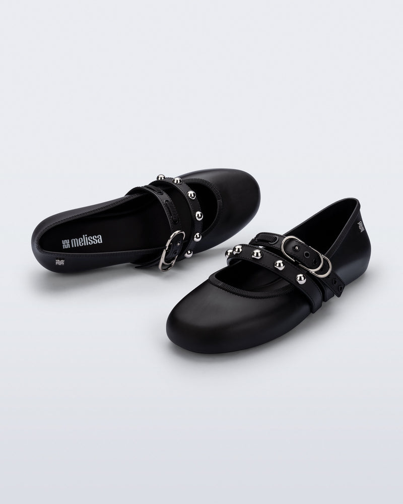 Top and angled view of a pair of black Soft Ballerina Studs flats with silver embellishments