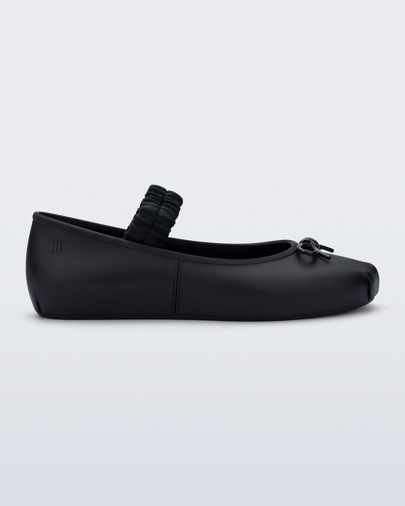 Side view of a black Sophie Scrunch flat