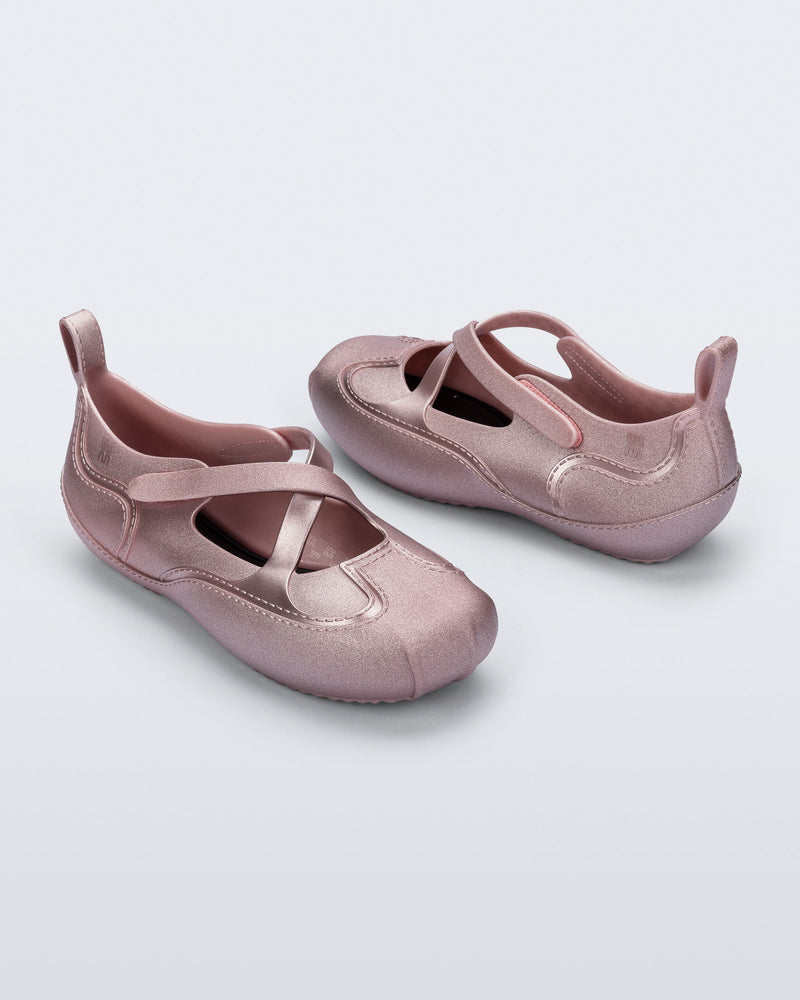 Back and angled view of a pair of pearly pink Aira flats with top straps