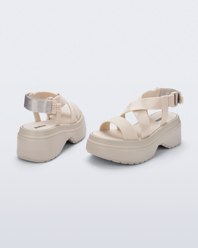 back and angled view of a pair of beige Stand platform sandals