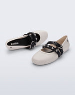 Top and angled view of a pair of beige Soft Ballerina Studs flats with black straps and silver embellishments