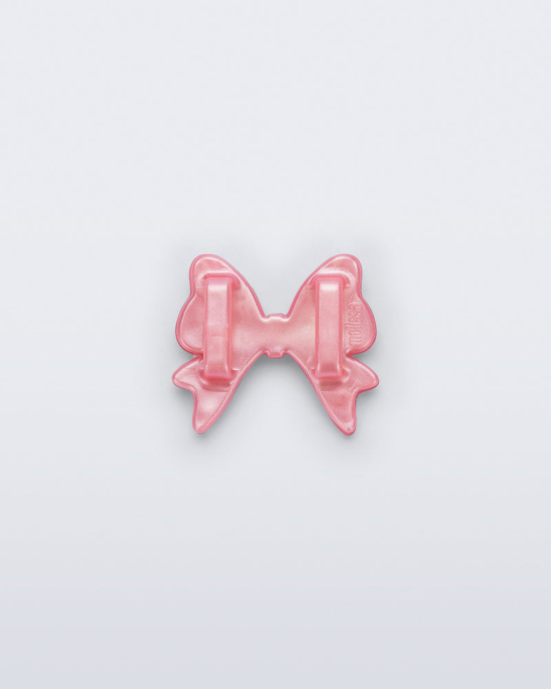 Back view of a pearly pink bow shoe charm