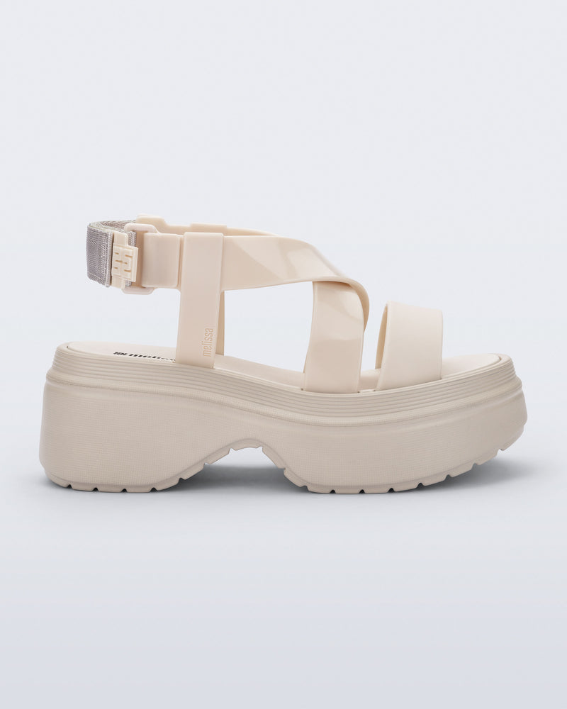 Side view of a beige Stand platform sandal