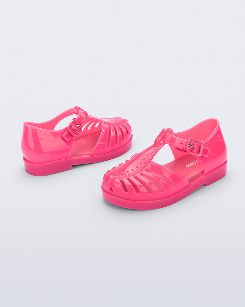 Side and angled view of a pair of pink Aranha 79 baby flats with buckle