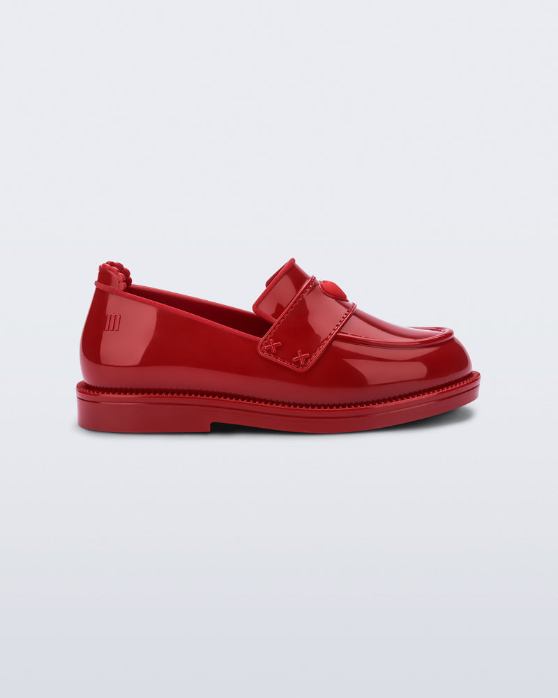 Side view of a red Royal Love baby loafer