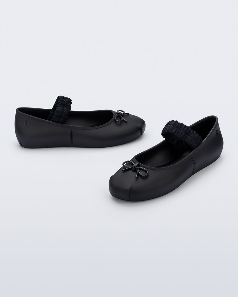 Side and angled view of a pair of black Sophie Scrunch flats