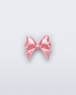 Front view of a pearly pink bow shoe charm