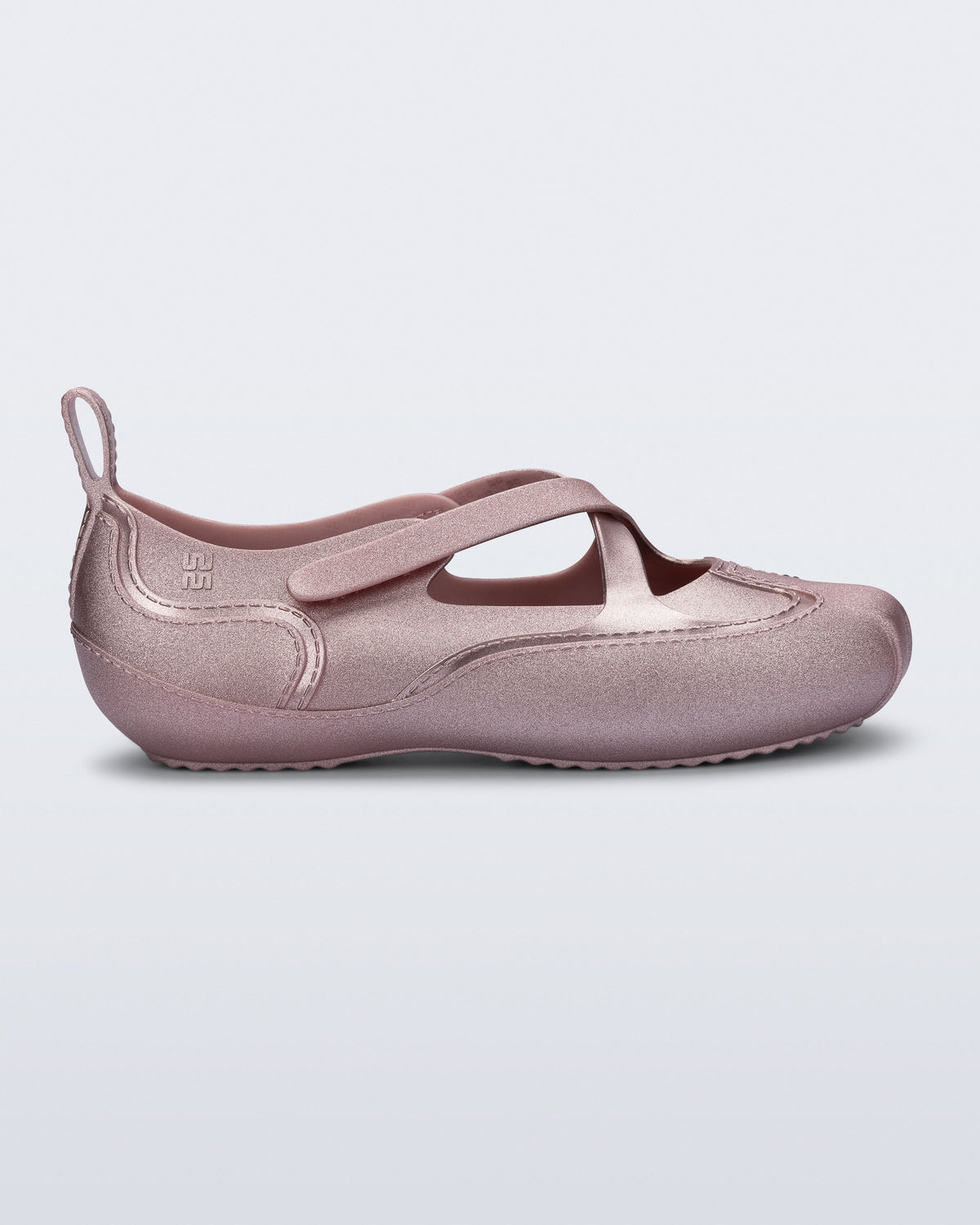 Side view of a pearly pink Aira flat with top straps
