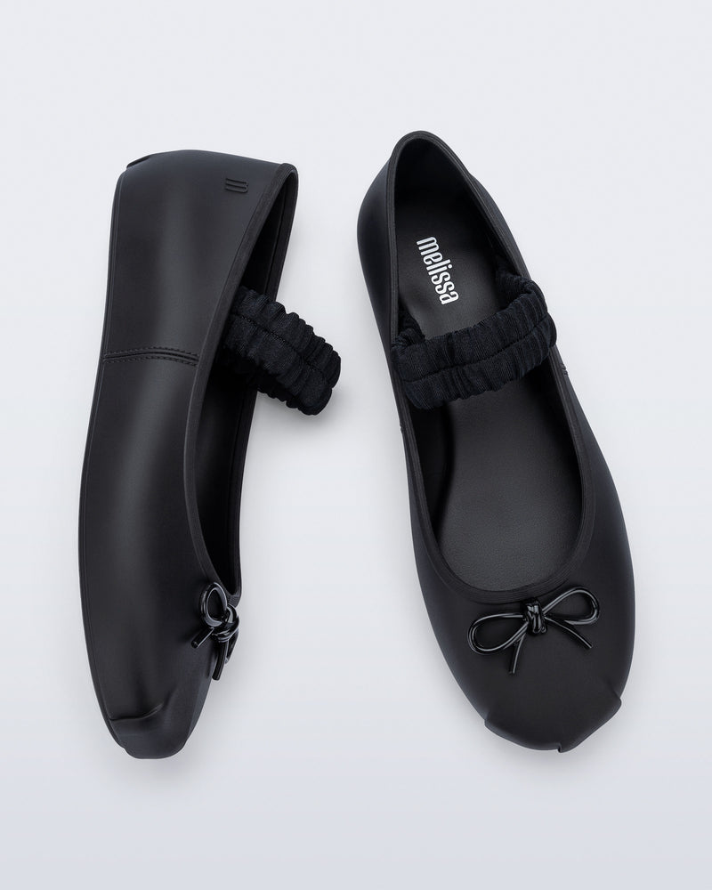 Side and top view of a pair of black Sophie Scrunch flats