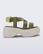 Side view of a beige Stand platform sandal with army green straps