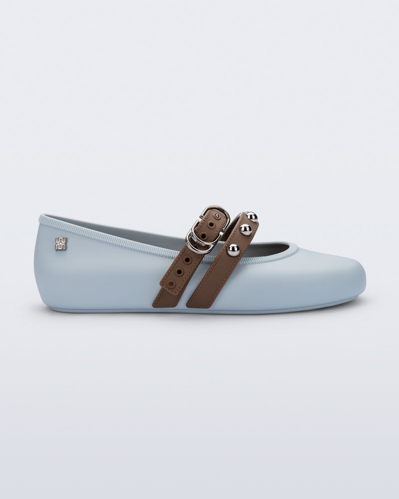 Side view of a blue Soft Ballerina Studs flat with brown straps and silver embellishments