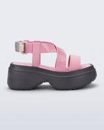 Side view of a pink Stand platform sandal with dark grey sole