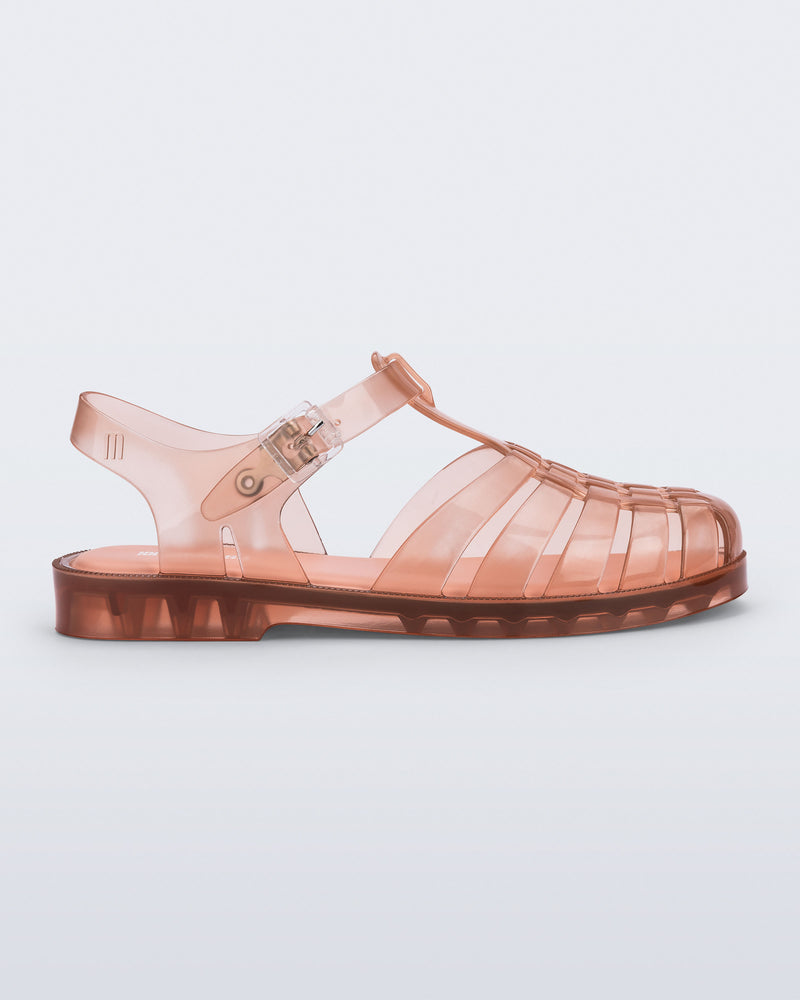 Side view of a clear peach Possession fisherman sandal