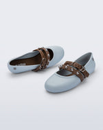 Top and angled view of a pair of blue Soft Ballerina Studs flats with brown straps and silver embellishments