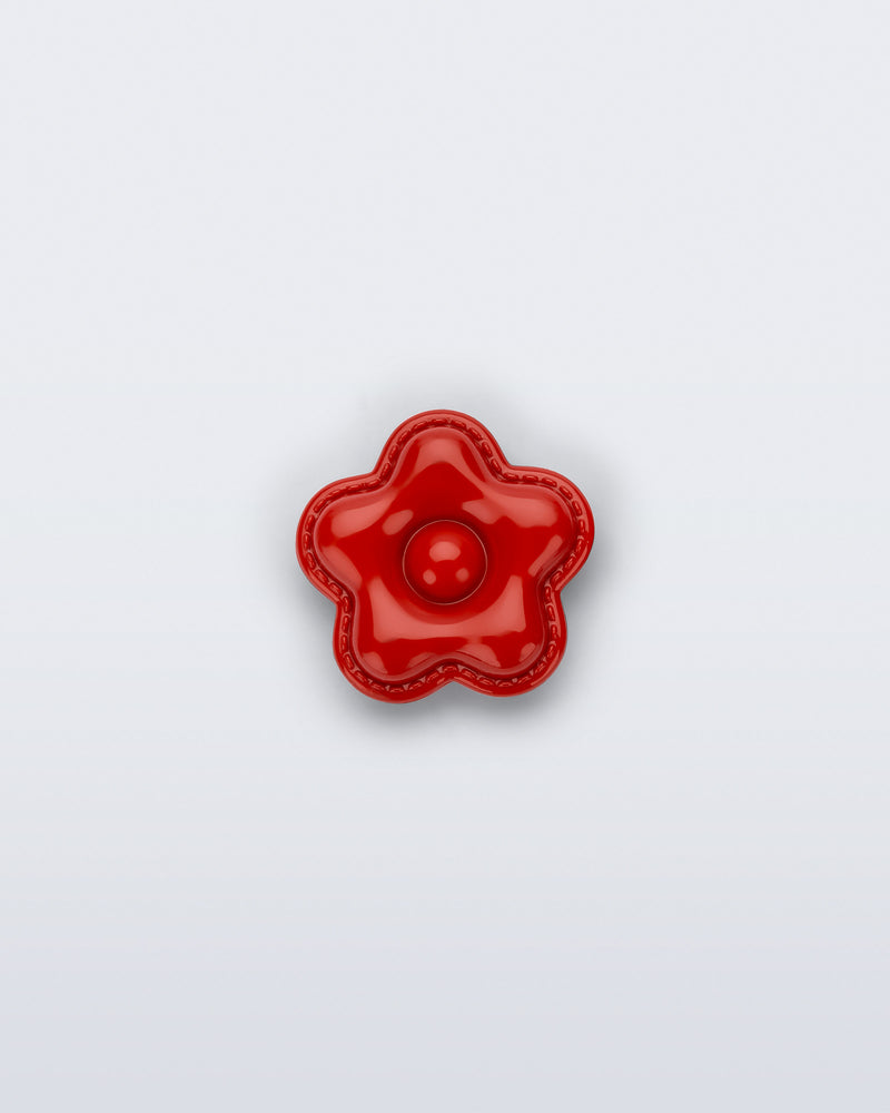 Front view of a red flower shoe charm