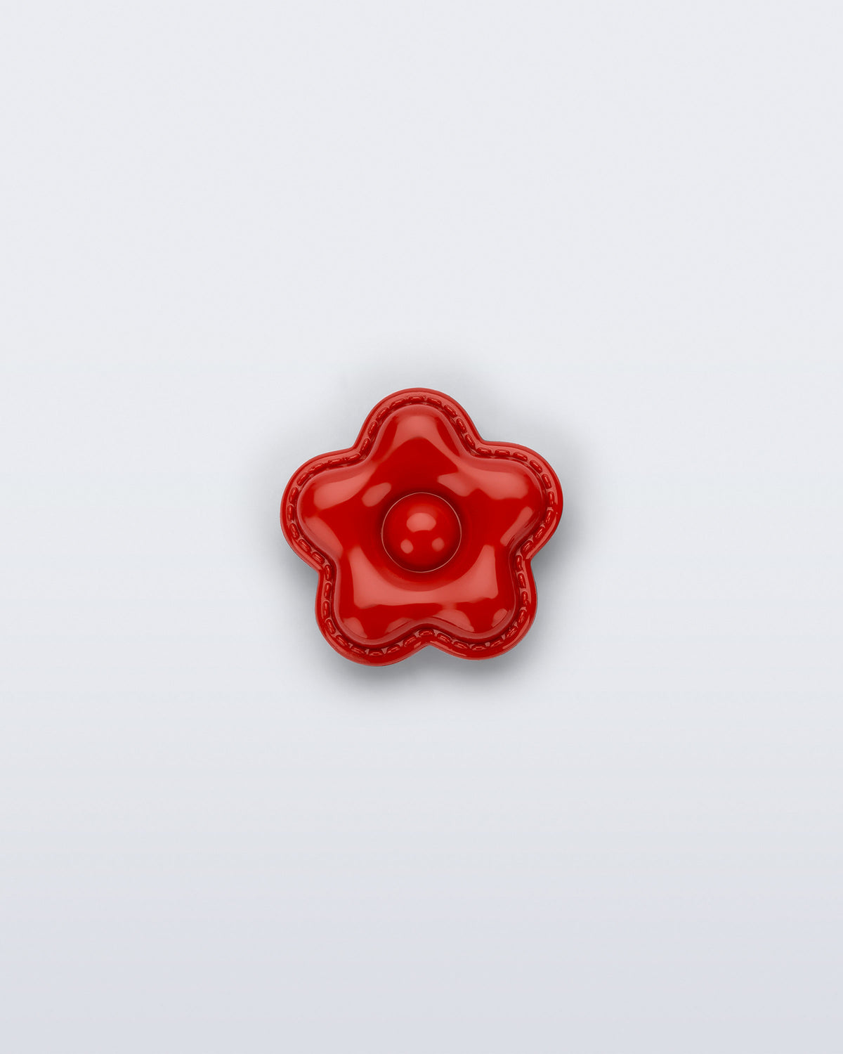 Front view of a red flower shoe charm