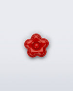 Front view of a red flower shoe charm