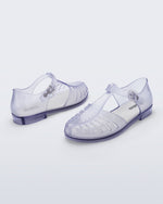 Back and angled view of a pair of clear Aranha 79 flats with buckle
