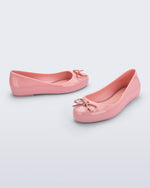 Side and angled view of a pair of pink Sweet Love Chrome kids flats with metallic pink bow
